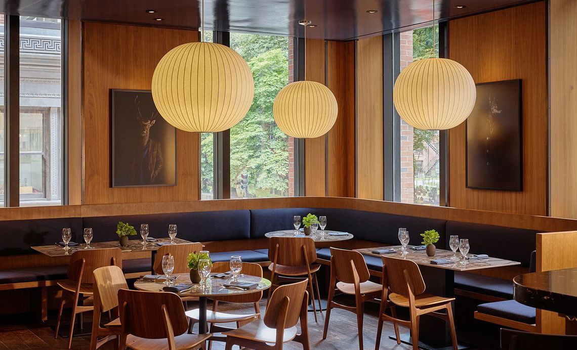 An attractive woman raising a glass during dinner