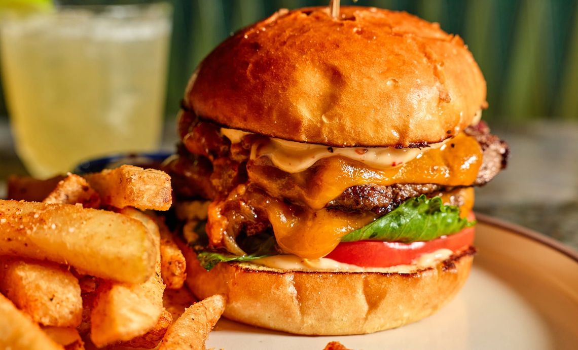 An attractive woman raising a glass during dinner