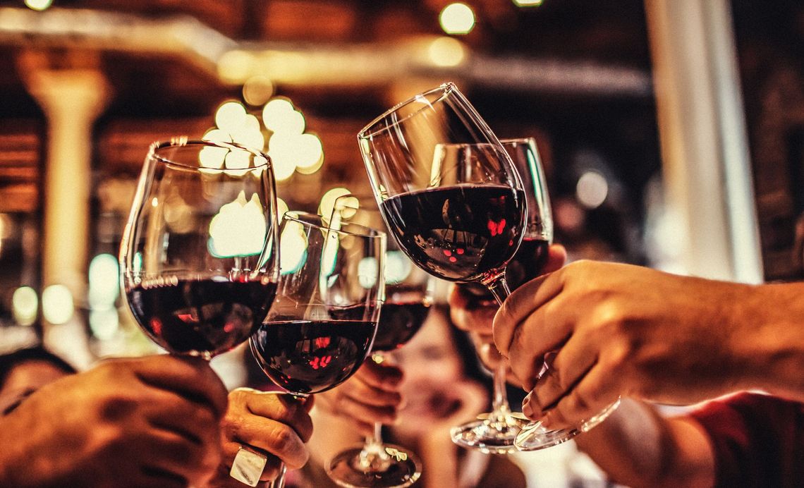 group of people toasting to wine